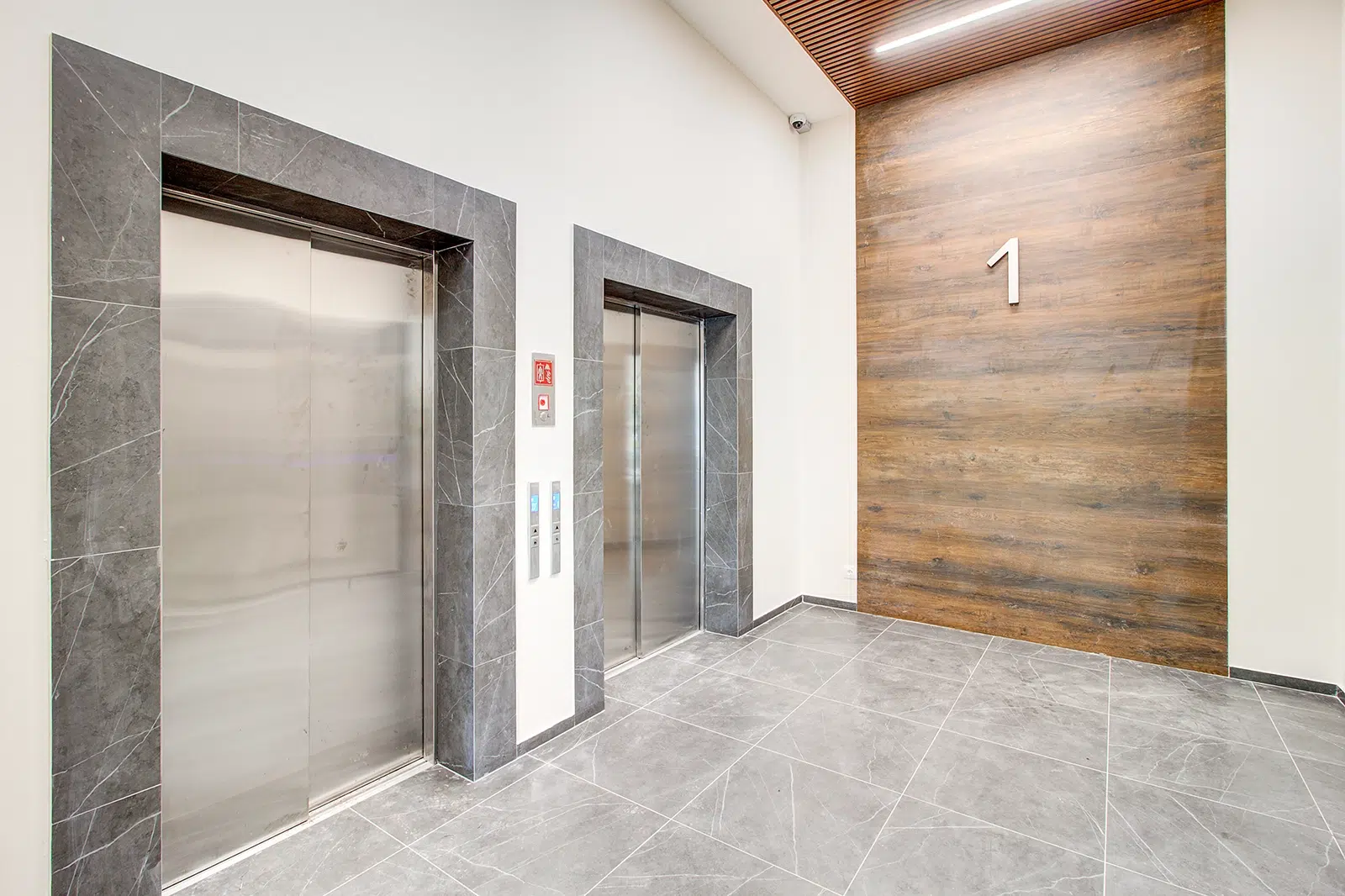 A Lobby with two lifts in a common area of a strata apartment building in Cairns, Qld