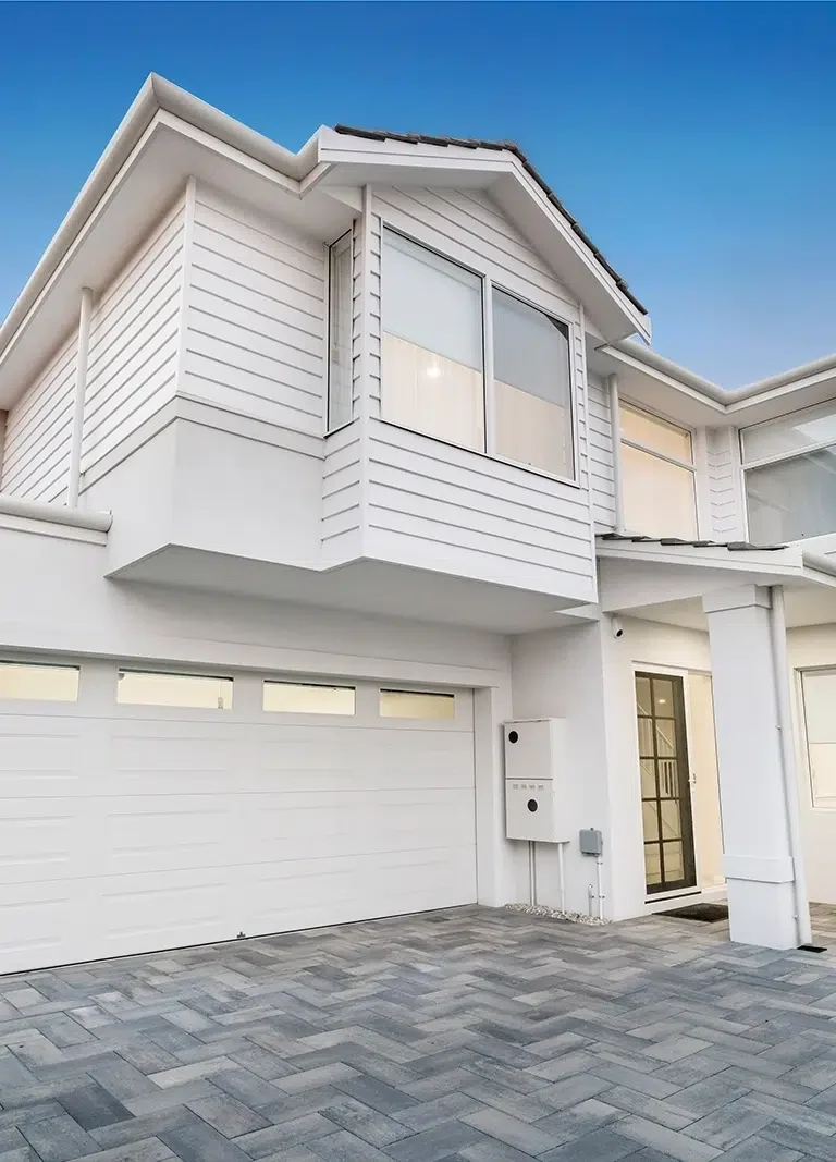 A large white home with freshly painted by Prime Coat, Residential Exterior Painters in Cairns, Qld